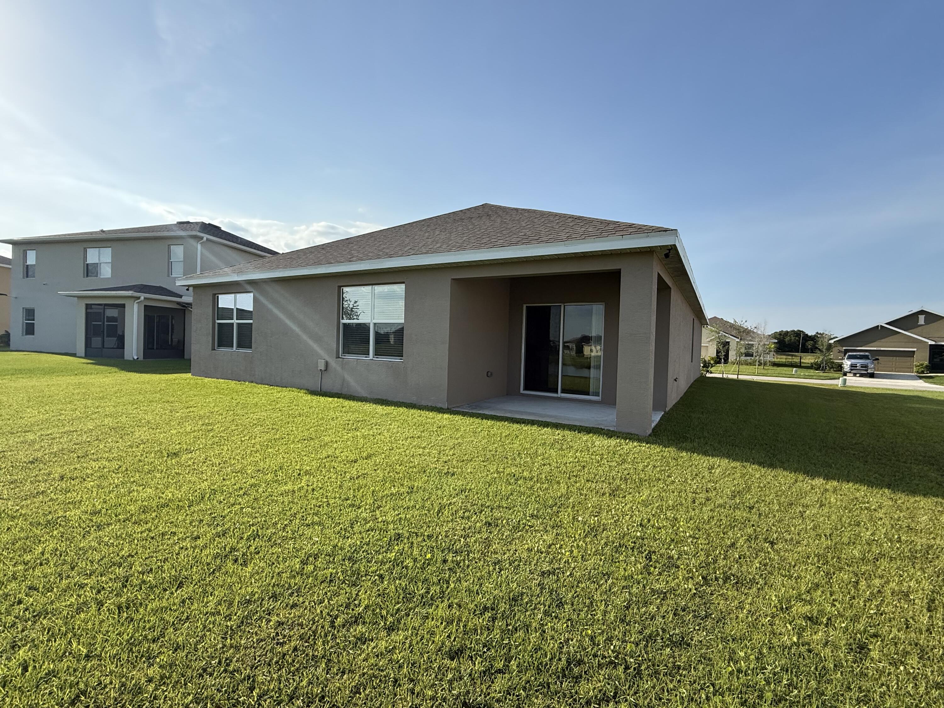 9511 Potomac Drive Fort Pierce, FL 34945 - Photo 25 of 26 a house view with a garden space