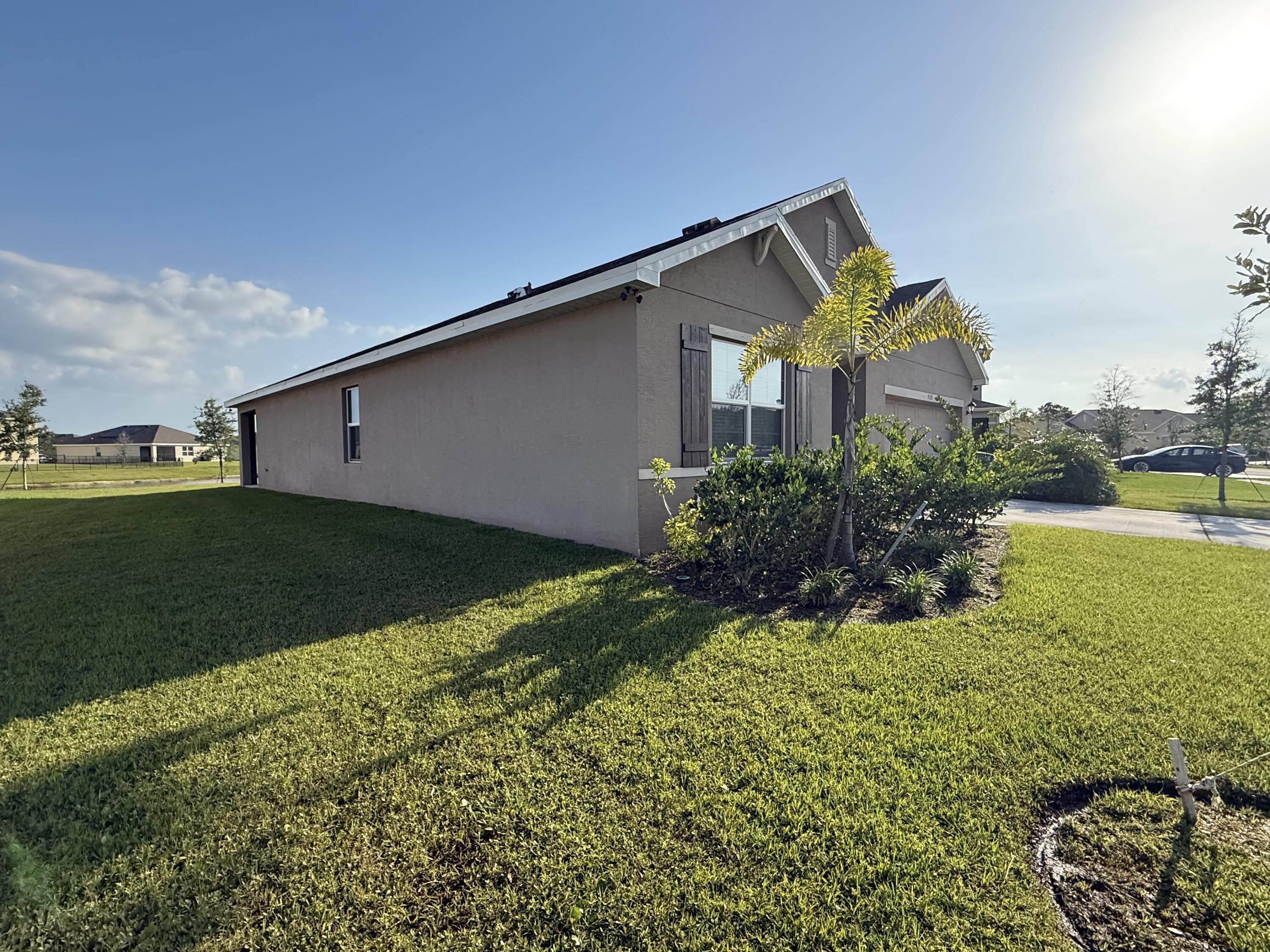 9511 Potomac Drive Fort Pierce, FL 34945 - Photo 26 of 26 a house view with garden space and a street view