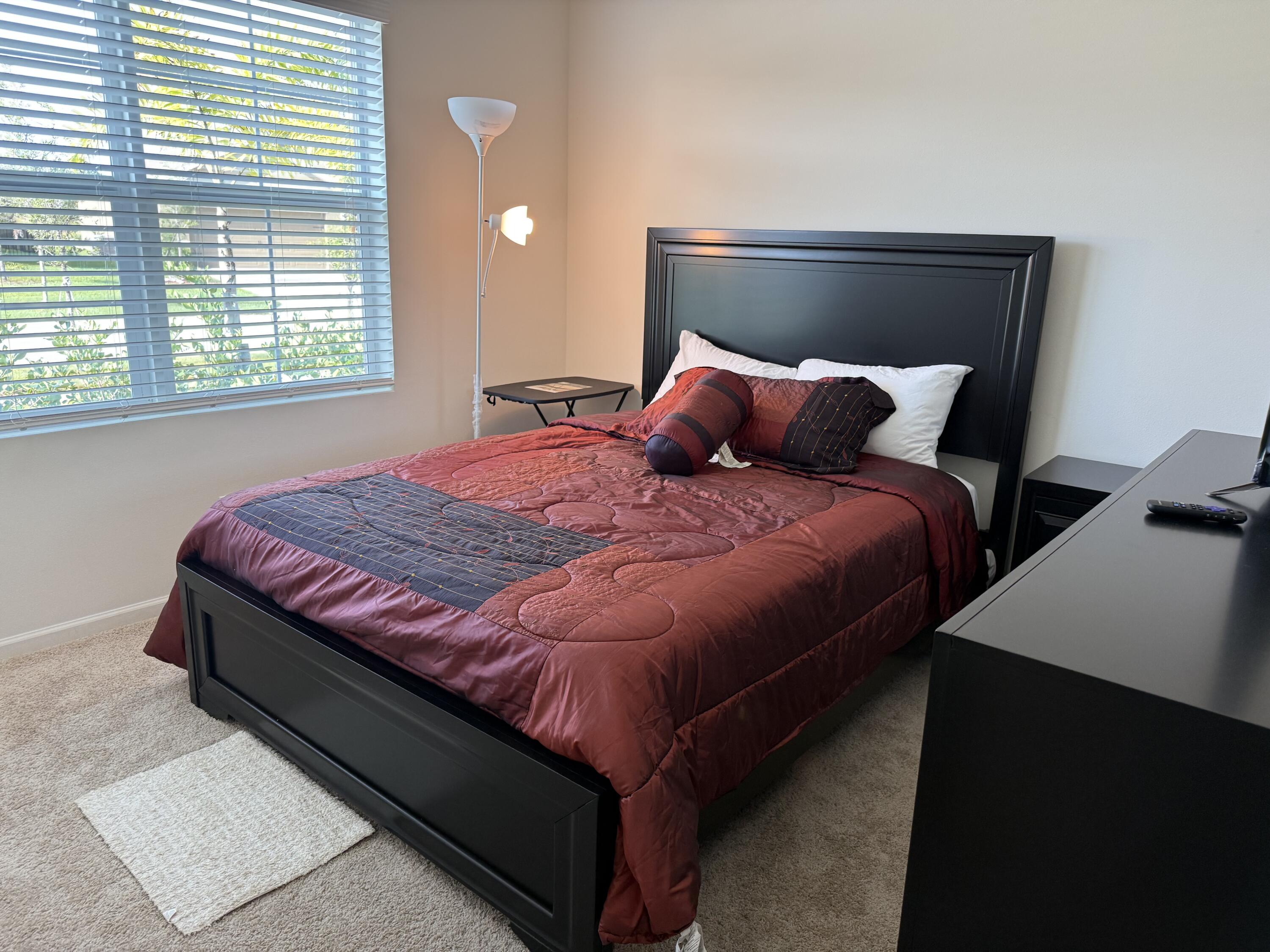 9511 Potomac Drive Fort Pierce, FL 34945 - Photo 4 of 26 a large bed sitting in a bedroom next to a window