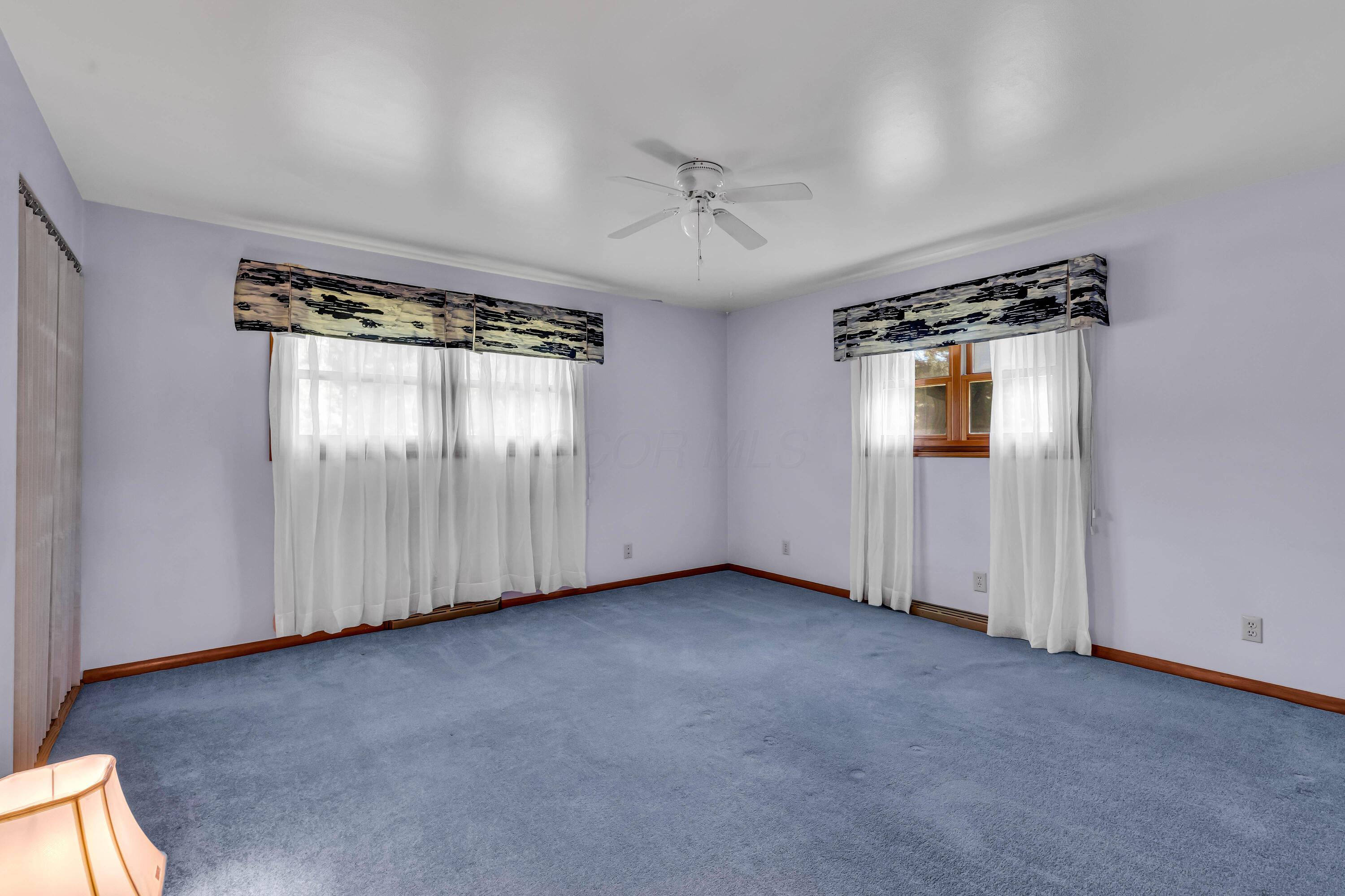 1213 East Cooke Road Columbus, OH 43224 - Photo 29 of 57 • Blue carpet • Hardwood flooring under carpet • Blue painted walls • Lighted ceiling fan • Lighted closet