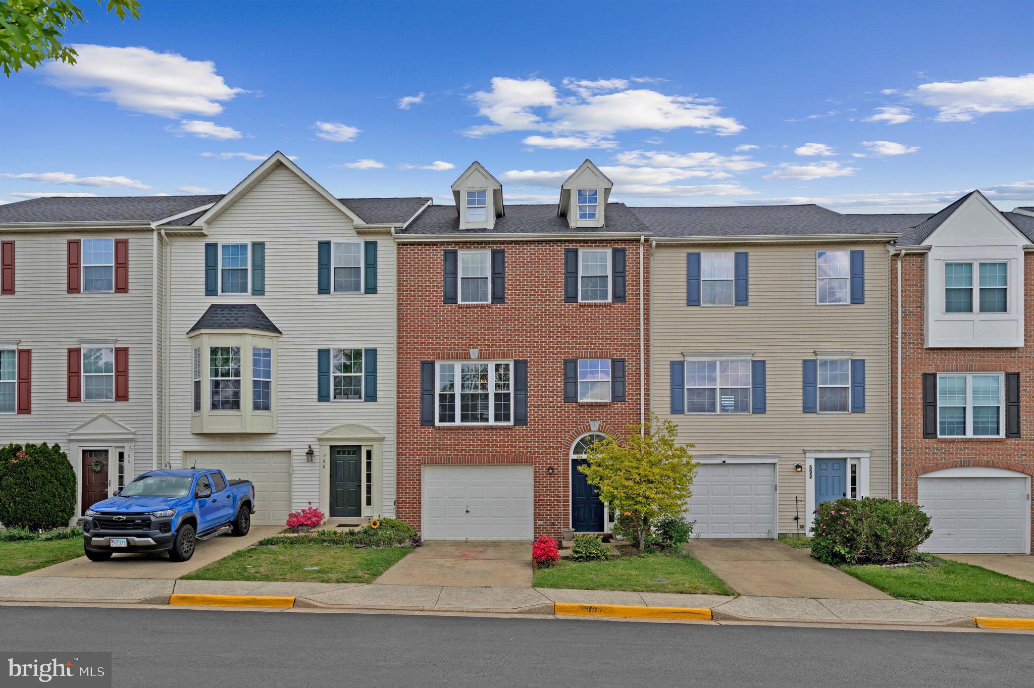 590 Tuliptree Square Northeast Leesburg, VA 20176 - Photo 1 of 54 a front view of a house with a yard