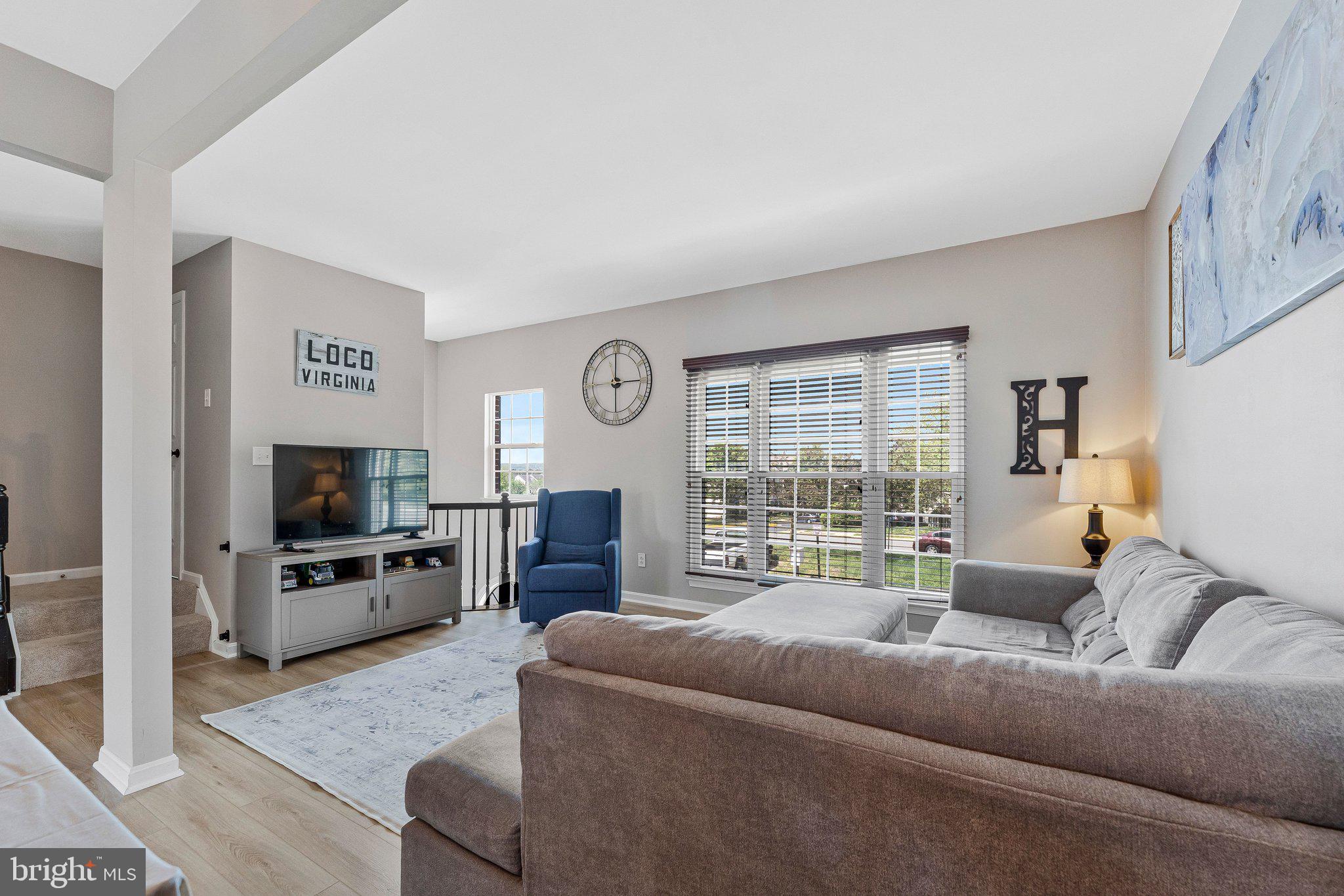590 Tuliptree Square Northeast Leesburg, VA 20176 - Photo 11 of 54 a living room with furniture and a flat screen tv