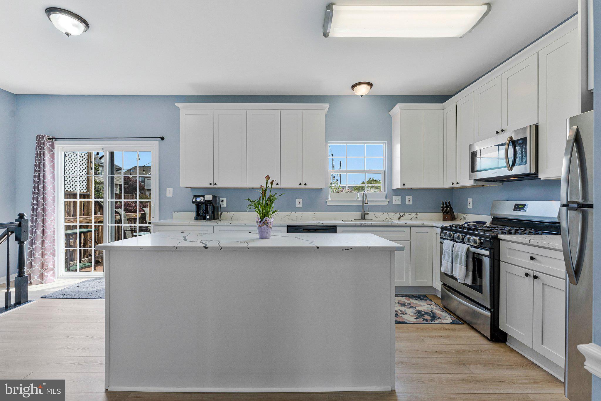 590 Tuliptree Square Northeast Leesburg, VA 20176 - Photo 14 of 54 a kitchen with stainless steel appliances granite countertop a stove a sink and a refrigerator