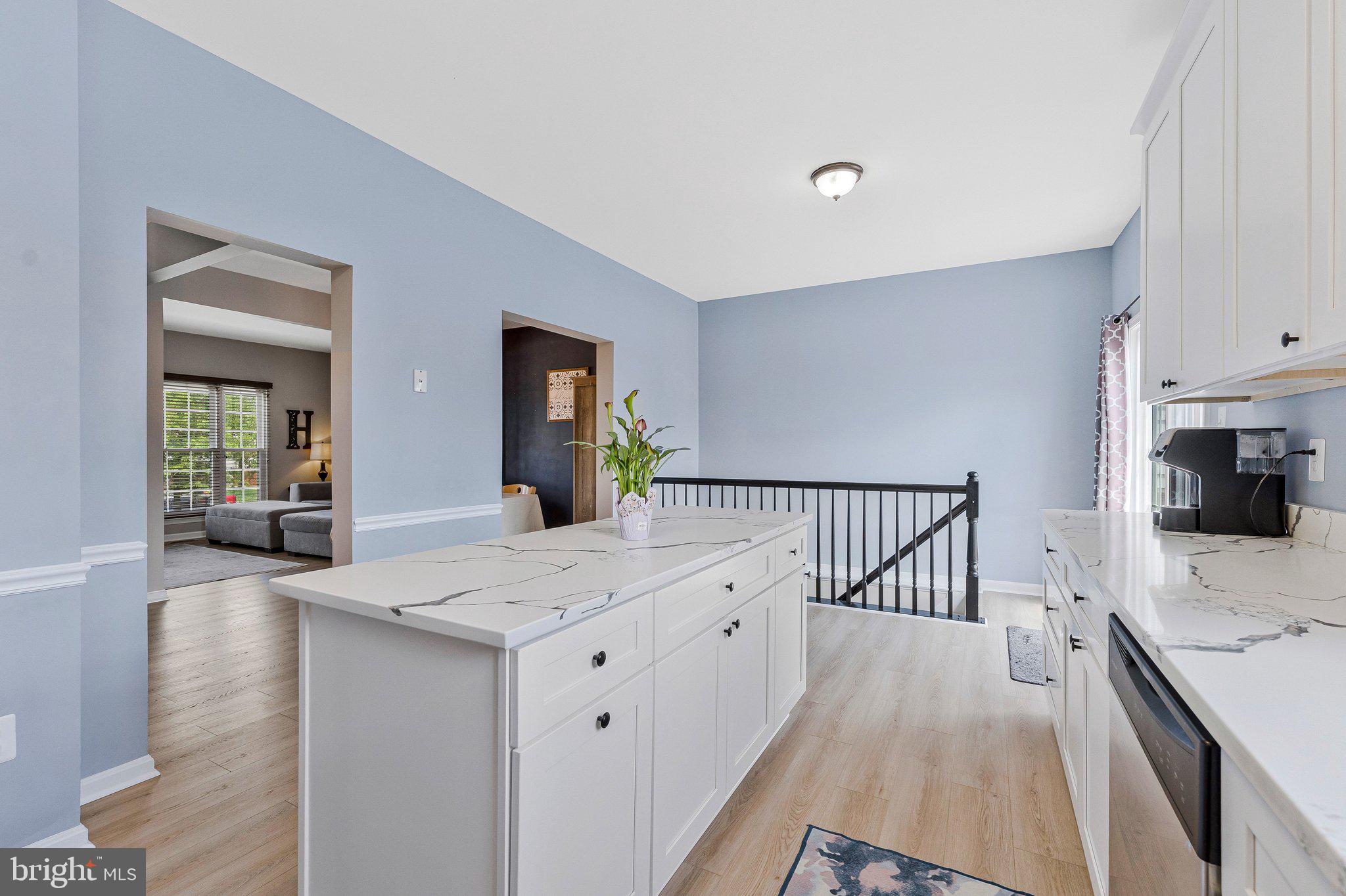 590 Tuliptree Square Northeast Leesburg, VA 20176 - Photo 18 of 54 a open kitchen with white cabinets and wooden floor