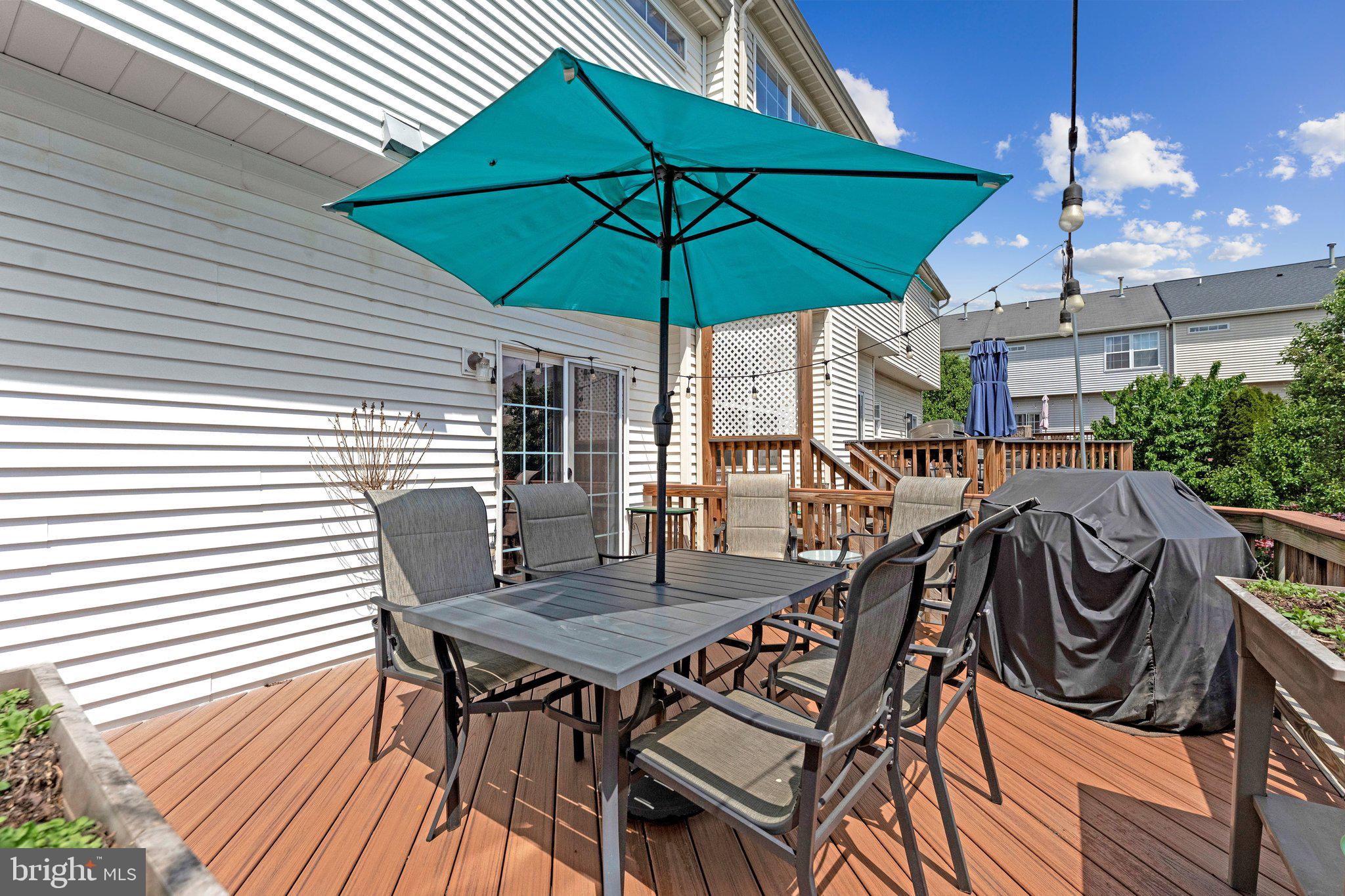 590 Tuliptree Square Northeast Leesburg, VA 20176 - Photo 20 of 54 an outdoor space with furniture and umbrella
