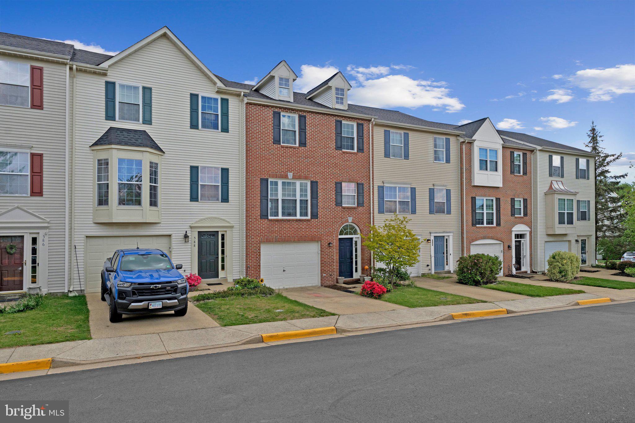 590 Tuliptree Square Northeast Leesburg, VA 20176 - Photo 2 of 54 a front view of multiple houses with yard