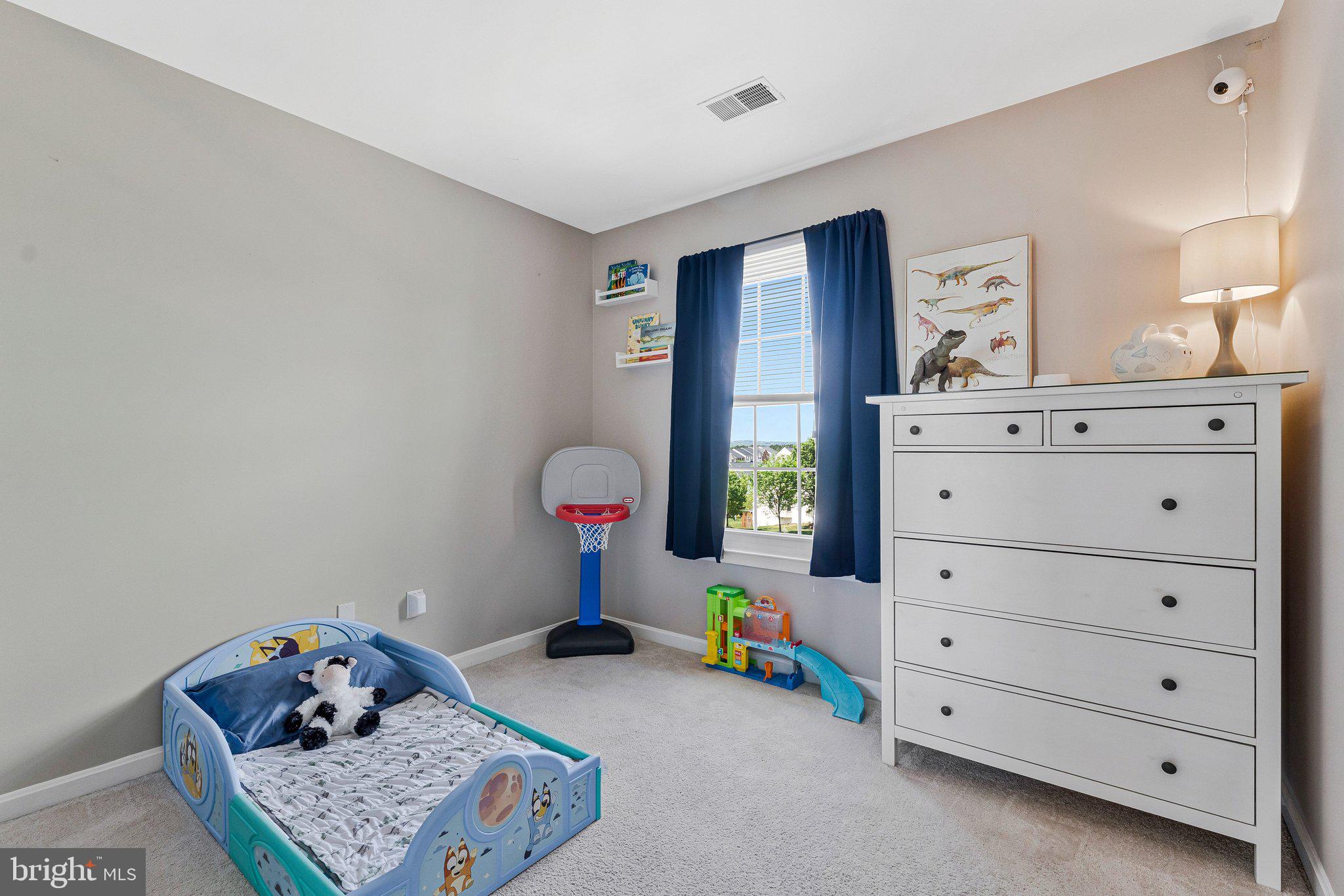 590 Tuliptree Square Northeast Leesburg, VA 20176 - Photo 23 of 54 a bedroom with a bed and a dresser