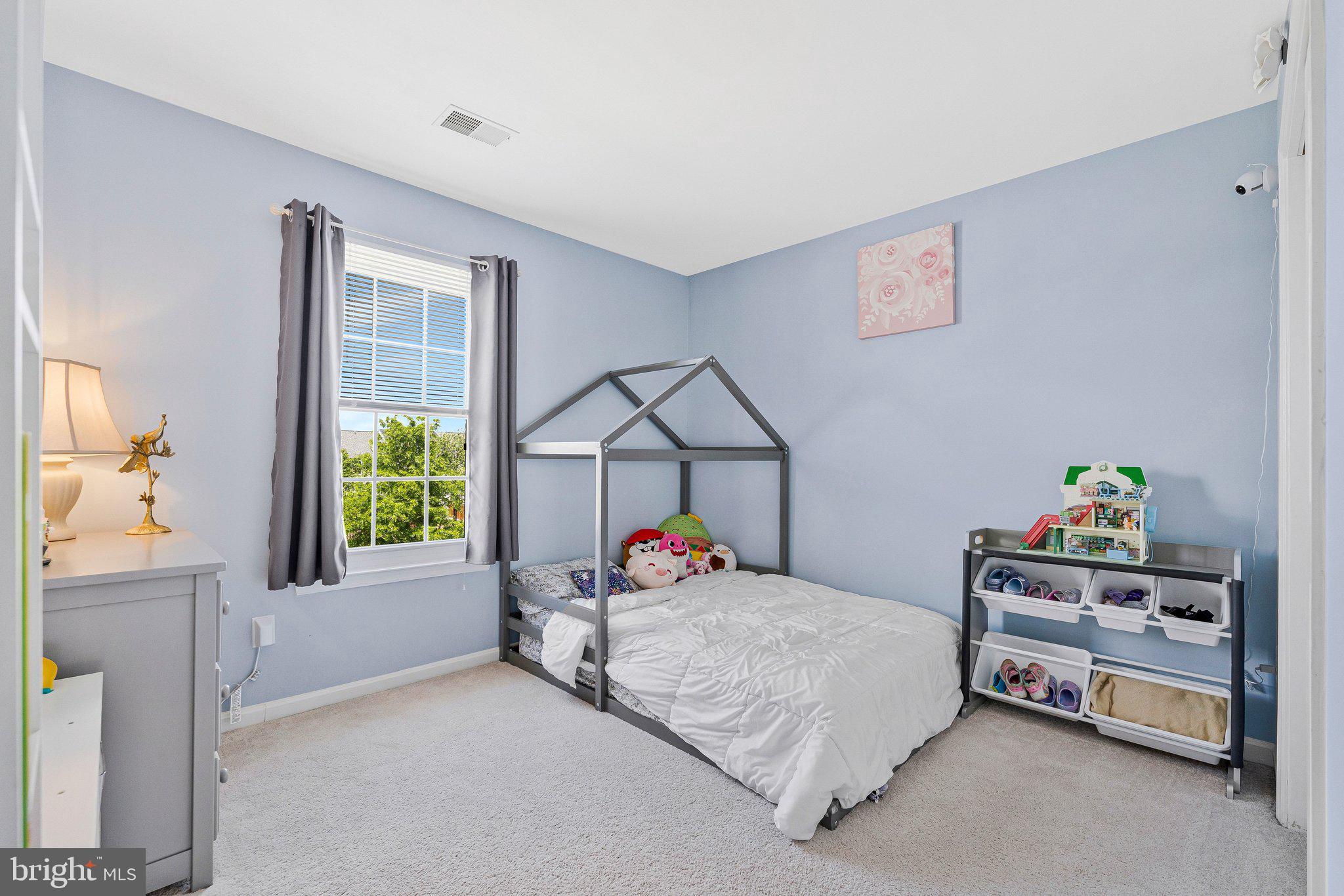 590 Tuliptree Square Northeast Leesburg, VA 20176 - Photo 28 of 54 a bedroom with a bed a window and dresser