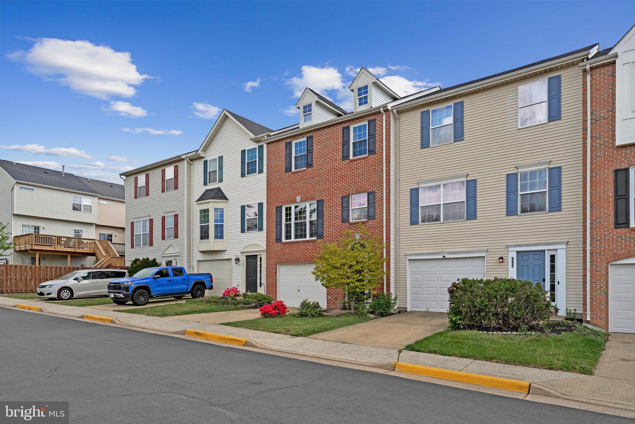 590 Tuliptree Square Northeast Leesburg, VA 20176 - Photo 3 of 54 a front view of multiple houses with yard