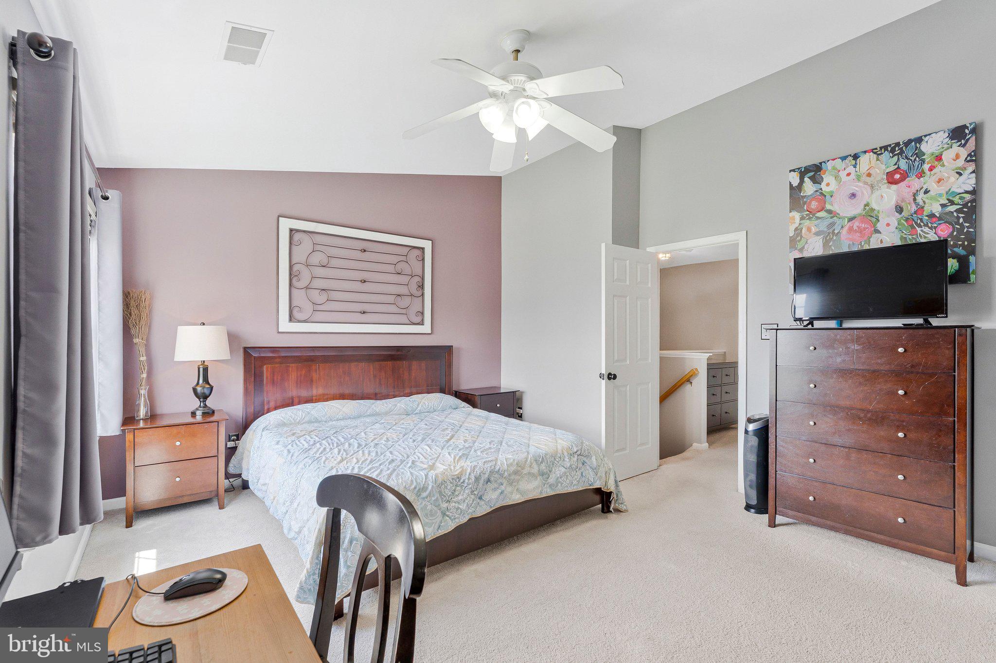 590 Tuliptree Square Northeast Leesburg, VA 20176 - Photo 32 of 54 a bedroom with a bed and a flat screen tv