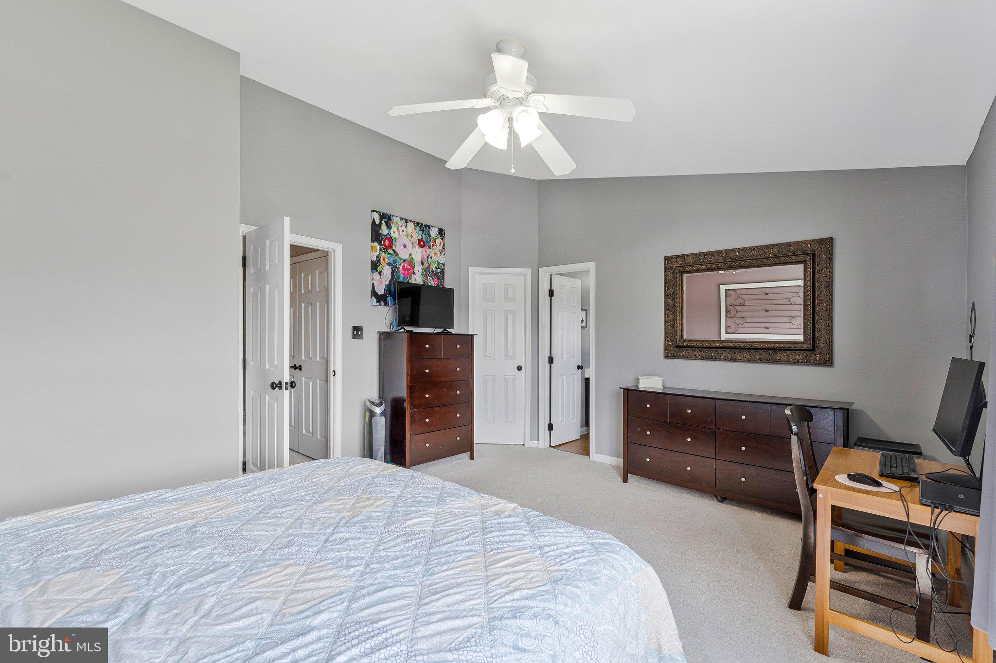 590 Tuliptree Square Northeast Leesburg, VA 20176 - Photo 33 of 54 a bedroom with a bed and a chandelier