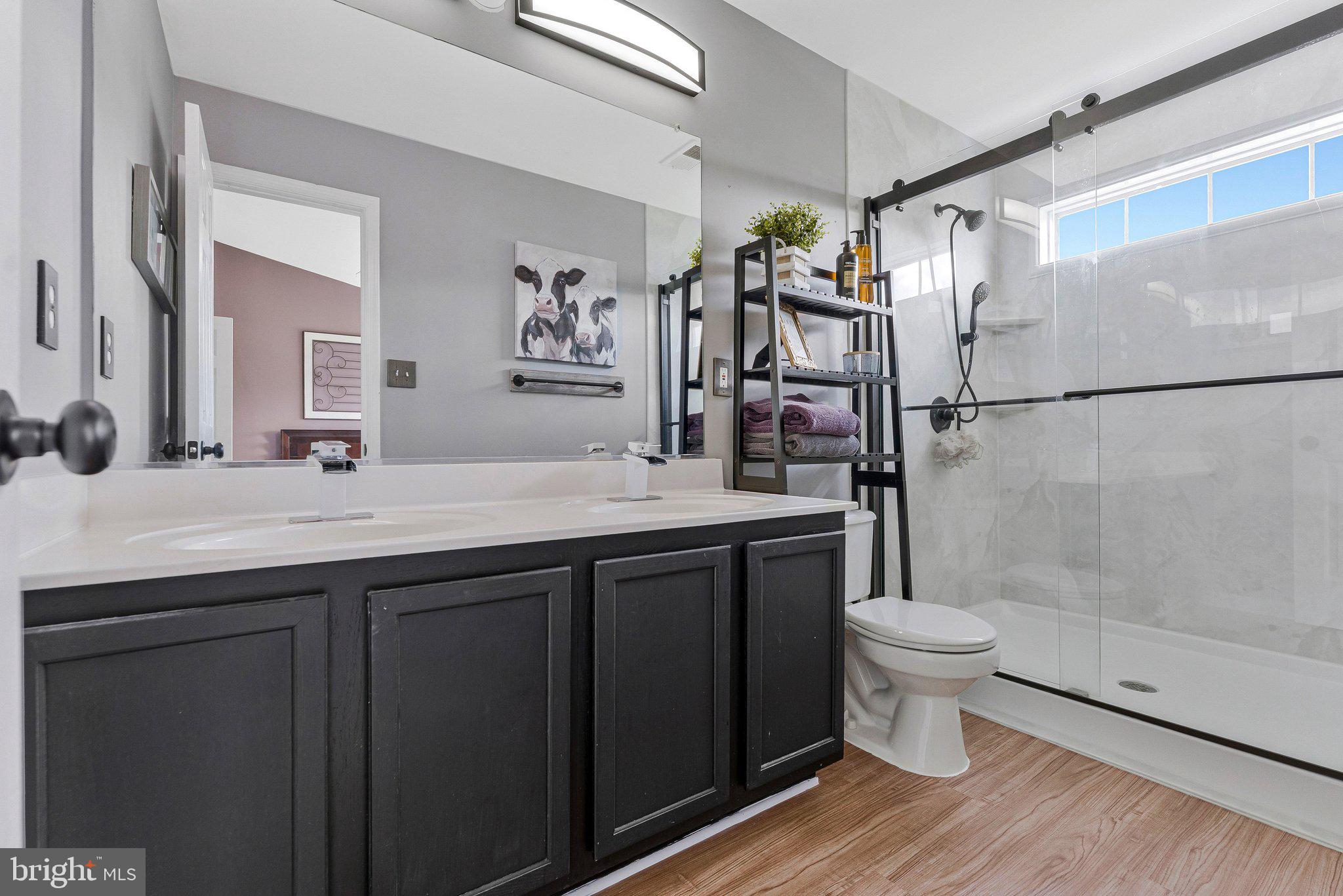 590 Tuliptree Square Northeast Leesburg, VA 20176 - Photo 34 of 54 a bathroom with a sink toilet a mirror and shower