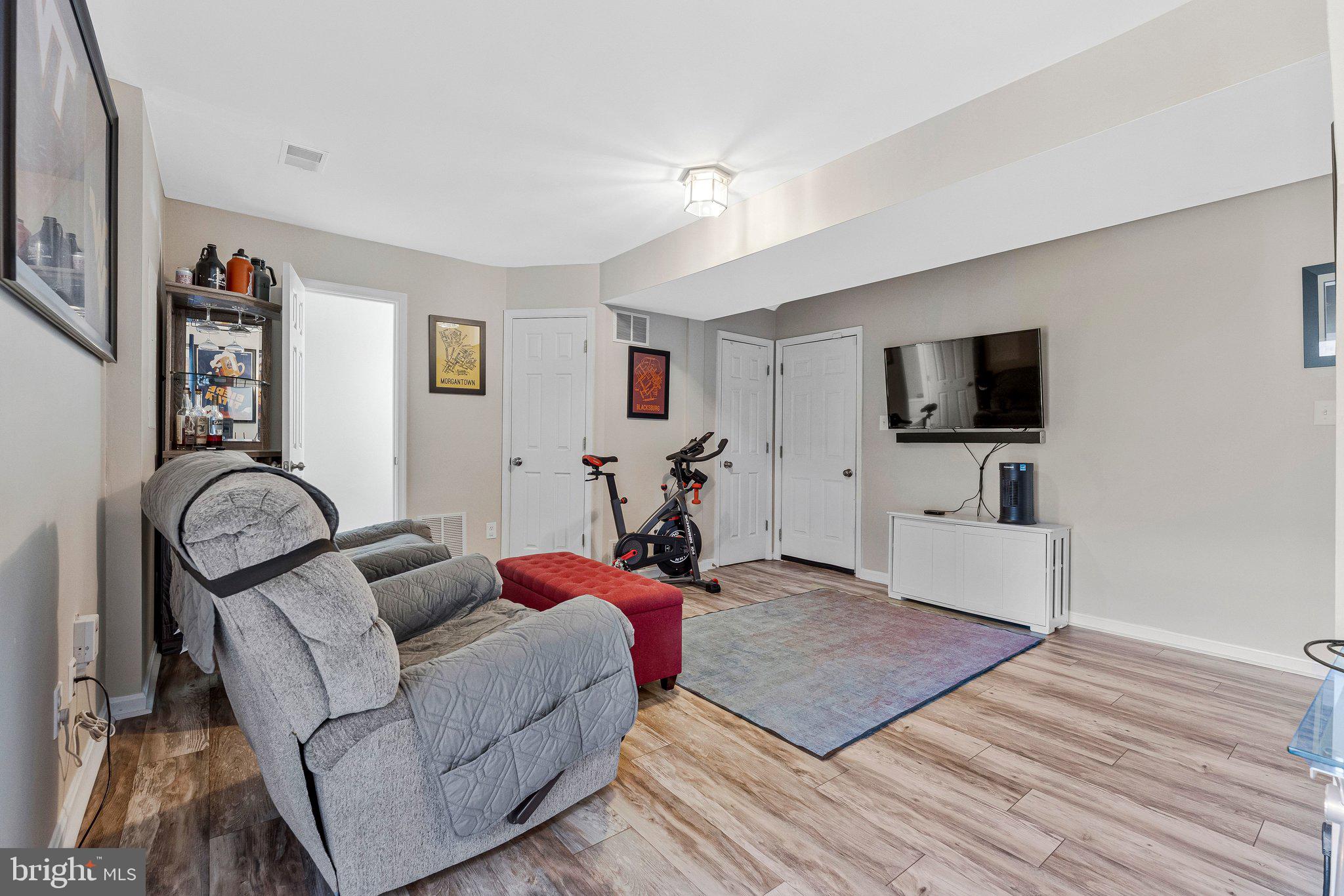 590 Tuliptree Square Northeast Leesburg, VA 20176 - Photo 38 of 54 a living room with furniture and a flat screen tv