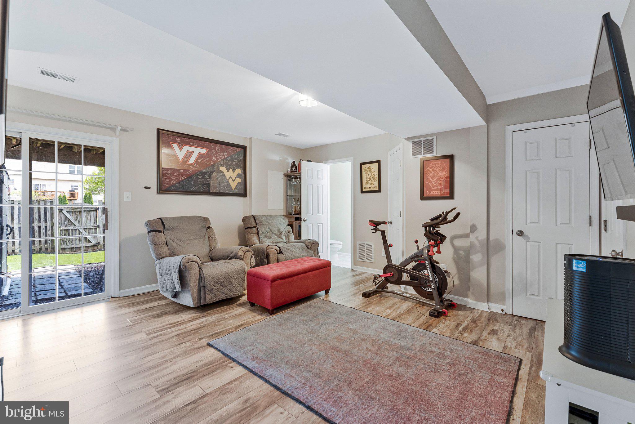 590 Tuliptree Square Northeast Leesburg, VA 20176 - Photo 39 of 54 a view of a livingroom with furniture and a flat screen tv