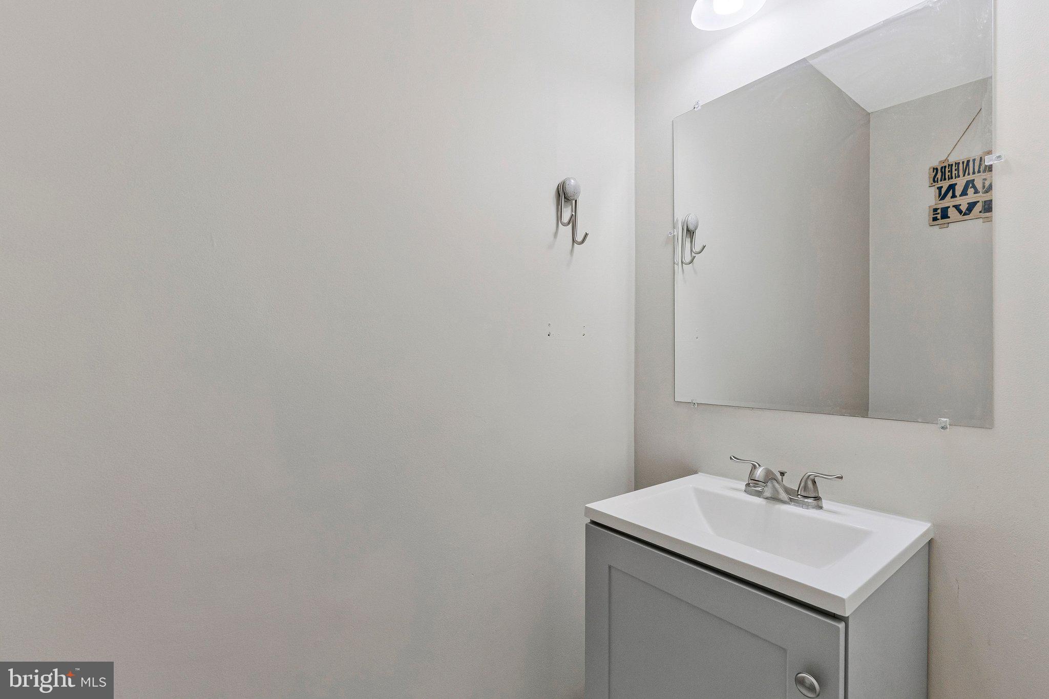 590 Tuliptree Square Northeast Leesburg, VA 20176 - Photo 40 of 54 a bathroom with a sink and a mirror