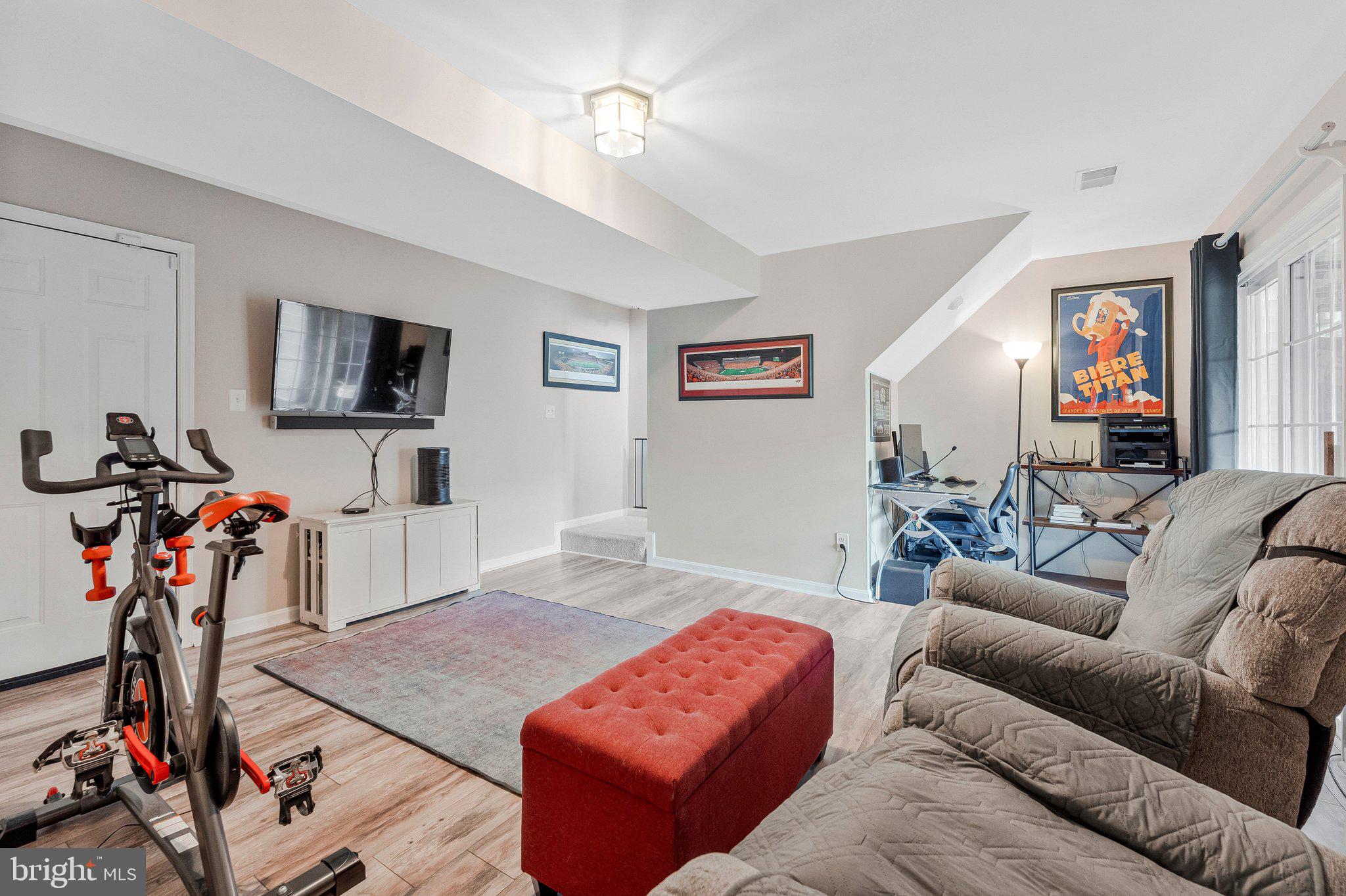 590 Tuliptree Square Northeast Leesburg, VA 20176 - Photo 41 of 54 a living room with furniture a flat screen tv and a window
