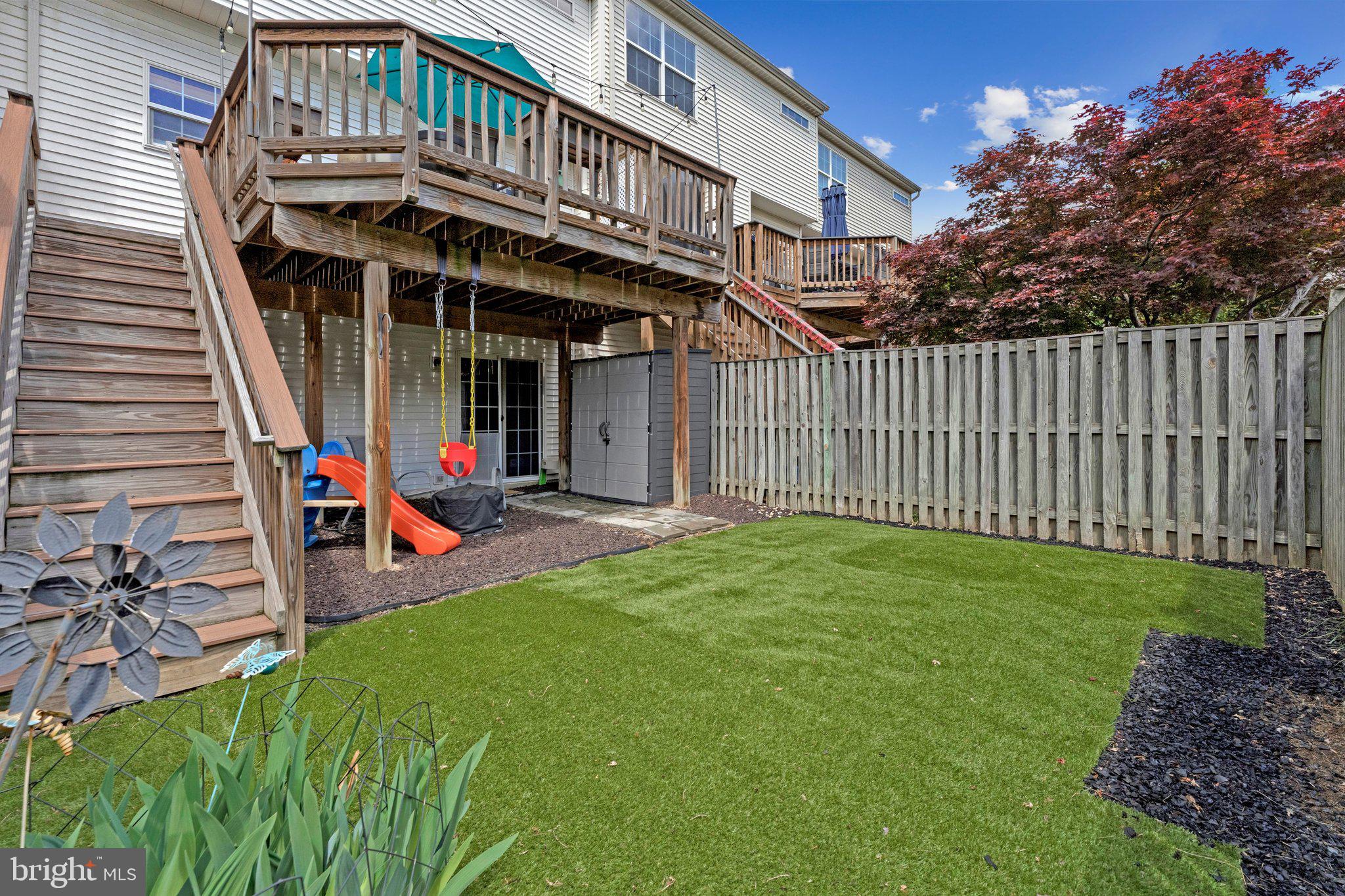 590 Tuliptree Square Northeast Leesburg, VA 20176 - Photo 42 of 54 a view of a house with a small yard and deck