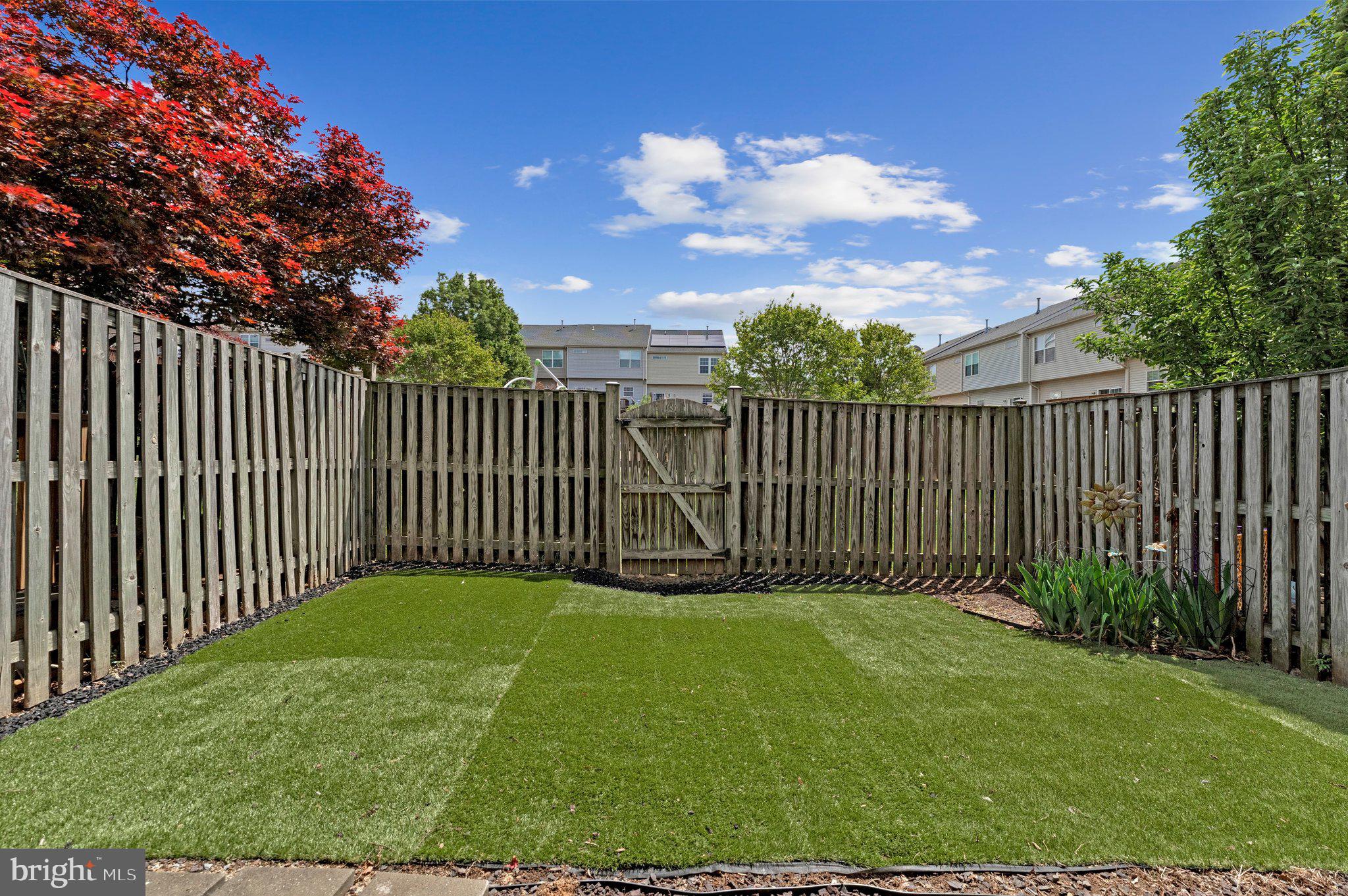 590 Tuliptree Square Northeast Leesburg, VA 20176 - Photo 45 of 54 a view of a yard with a bench