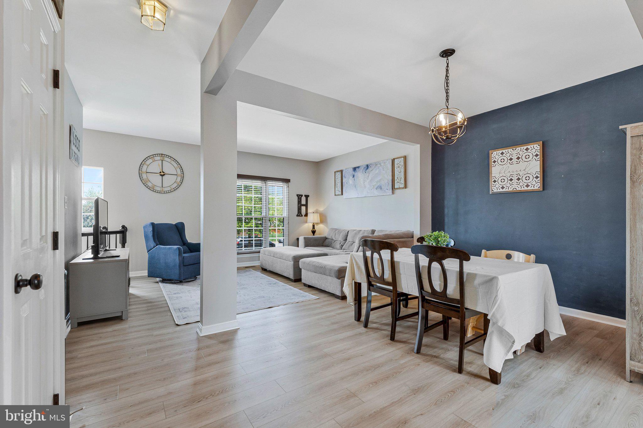 590 Tuliptree Square Northeast Leesburg, VA 20176 - Photo 6 of 54 a living room with furniture and a chandelier