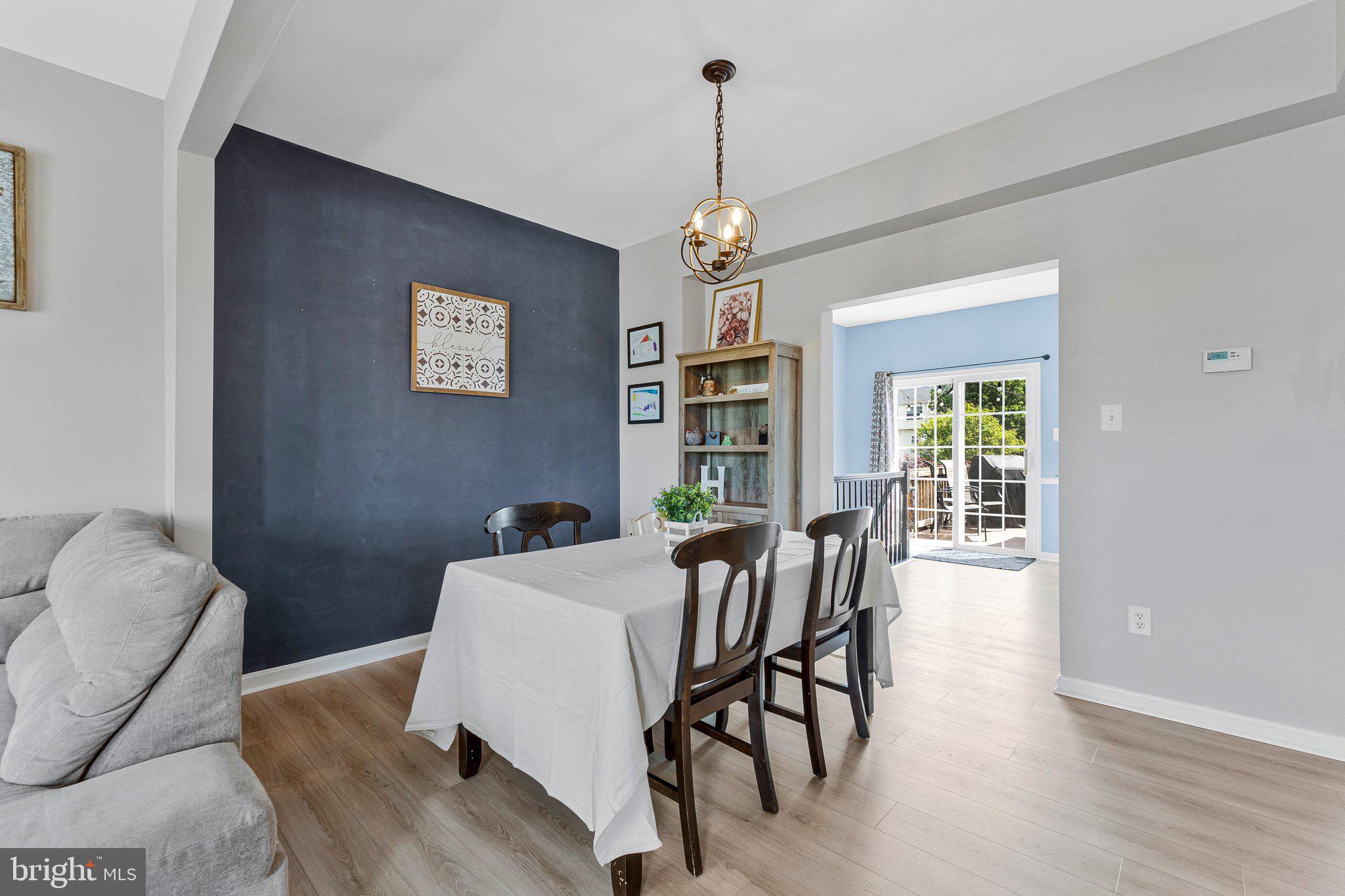 590 Tuliptree Square Northeast Leesburg, VA 20176 - Photo 8 of 54 a view of a dining room with furniture window and wooden floor