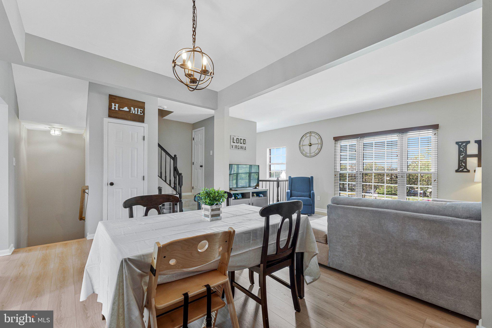 590 Tuliptree Square Northeast Leesburg, VA 20176 - Photo 9 of 54 a view of a dining room with furniture window and wooden floor