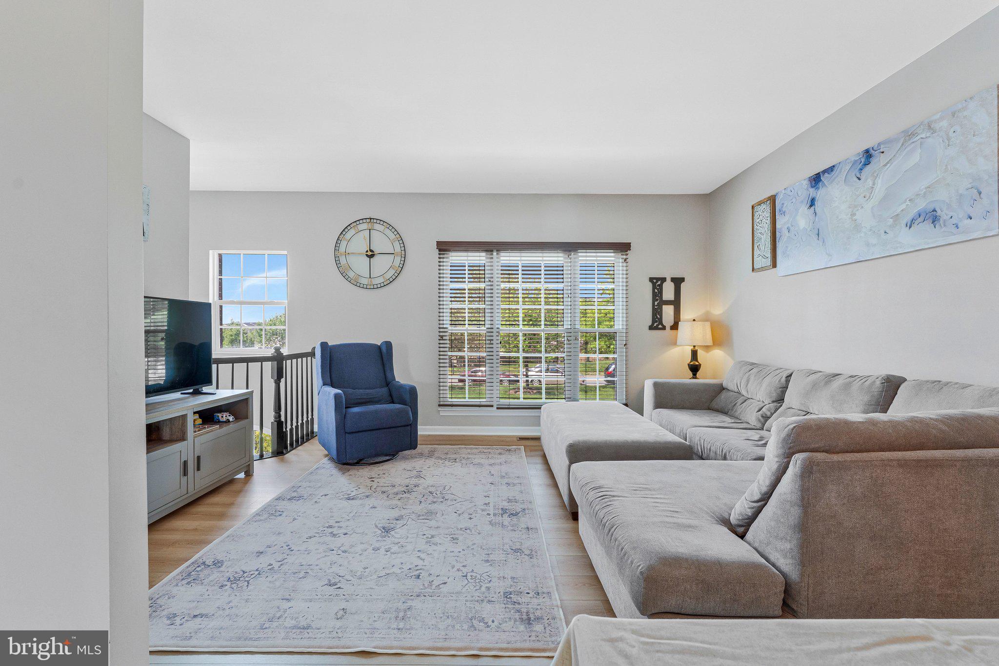 590 Tuliptree Square Northeast Leesburg, VA 20176 - Photo 10 of 54 a living room with furniture and a flat screen tv