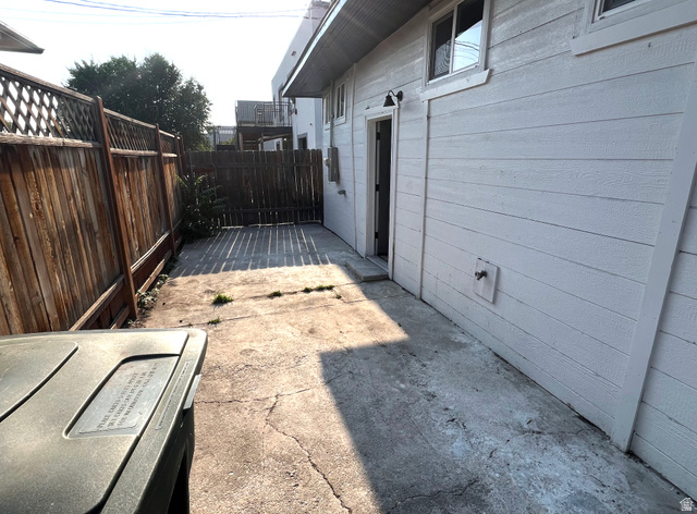 545 23rd Street Ogden, UT 84401 - Photo 22 of 28 Concrete patio area with wood plank fencing