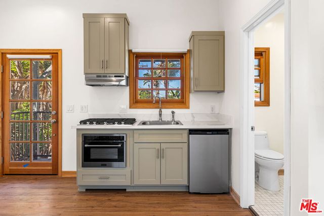 a kitchen with stainless steel appliances granite countertop a stove and a sink