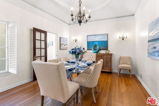 a view of a dining room with furniture wooden floor and chandelier