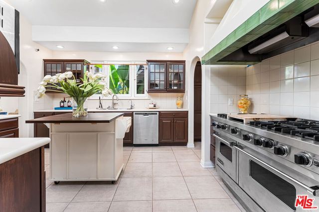 a kitchen with stainless steel appliances a stove a sink and a refrigerator