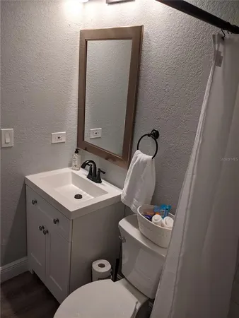 a bathroom with a shower curtain and a window