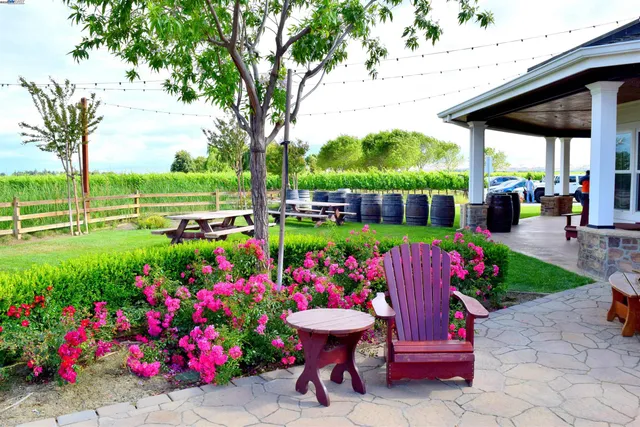 a view of a chairs and table in backyard of the house