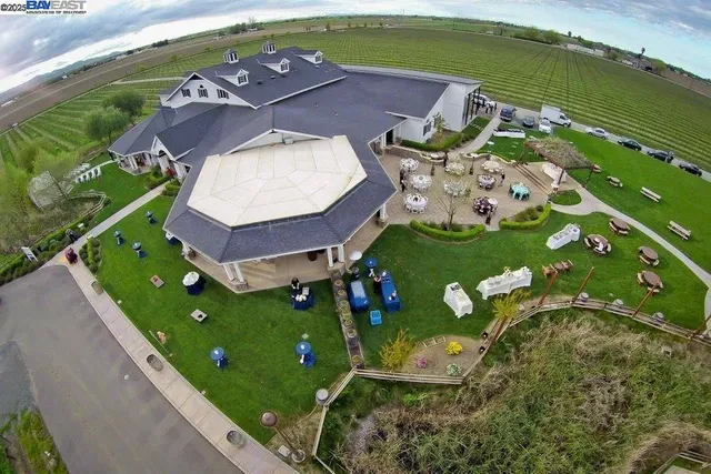 an aerial view of a house a garden and lake view
