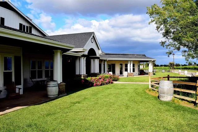 a front view of a house with swimming pool having outdoor seating