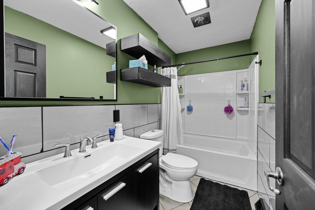 8012 10th Street West Rock Island, IL 61201 - Photo 19 of 27 a bathroom with a sink toilet and shower