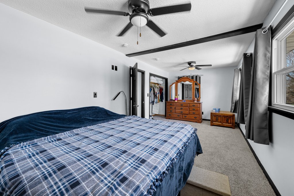 8012 10th Street West Rock Island, IL 61201 - Photo 20 of 27 a bedroom with a bed and a walk in closet