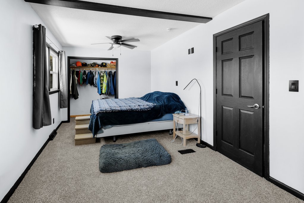8012 10th Street West Rock Island, IL 61201 - Photo 22 of 27 a bedroom with a bed and a walk in closet