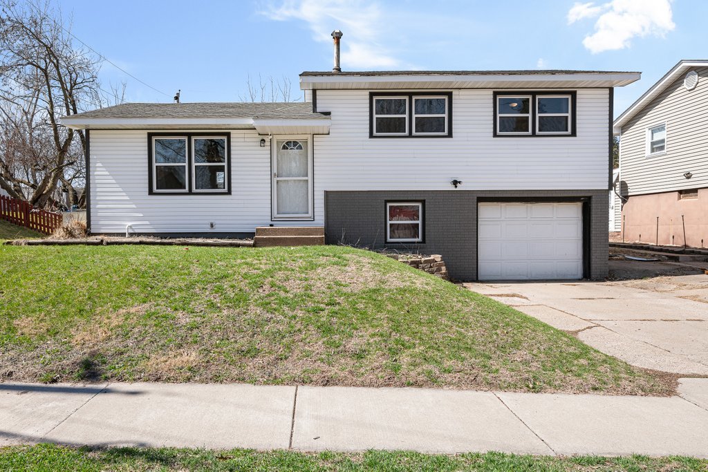 8012 10th Street West Rock Island, IL 61201 - Photo 4 of 27 a front view of a house with a yard