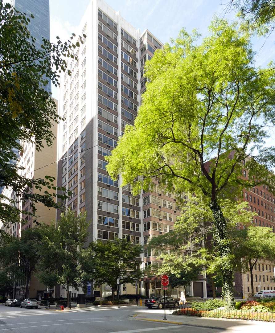 a view of a tall building next to a road