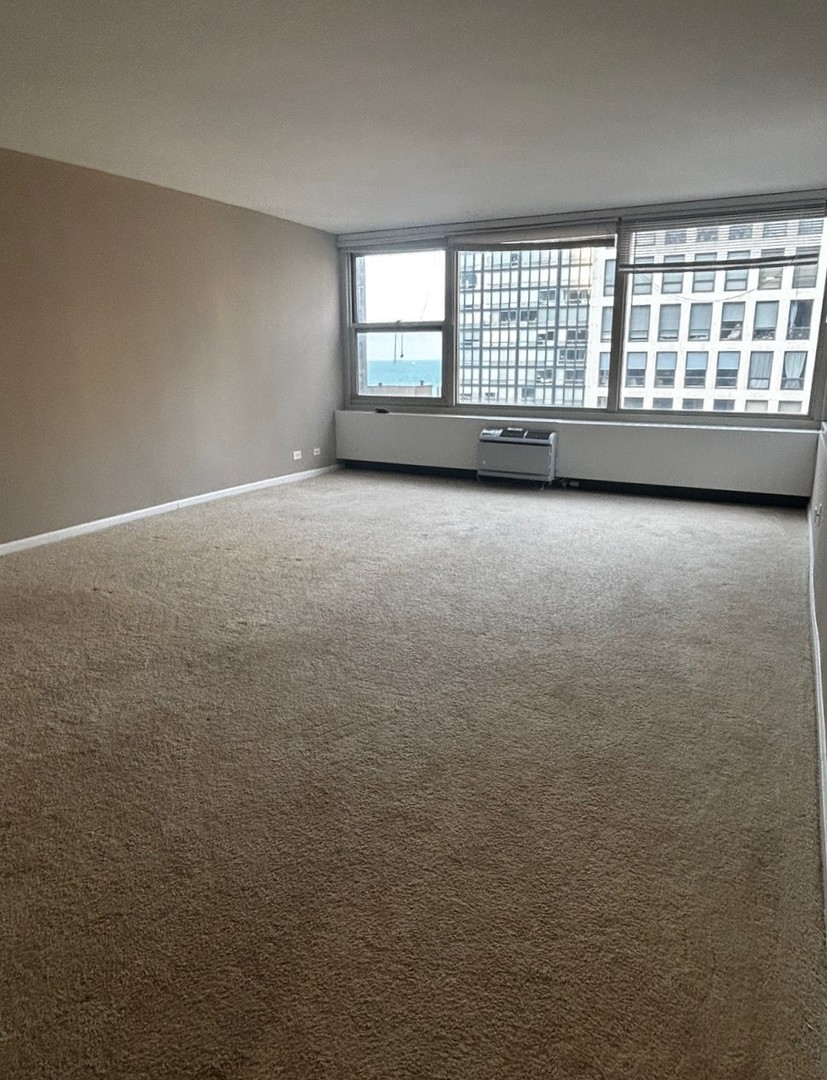 860 North Dewitt Place, Unit 1501 Chicago, IL 60611 - Photo 12 of 17 an empty room with a window