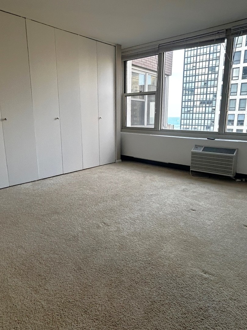860 North Dewitt Place, Unit 1501 Chicago, IL 60611 - Photo 7 of 17 a view of an empty room with a window