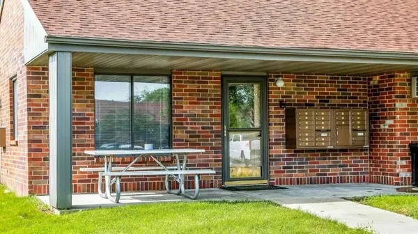 a view of a brick house with a large window