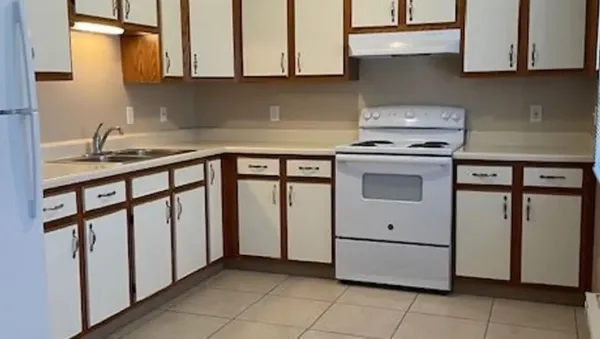 a kitchen with stainless steel appliances granite countertop a sink and a stove