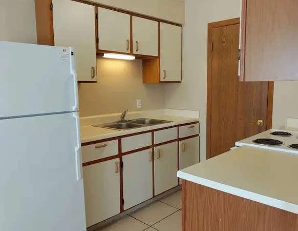 a kitchen with a refrigerator and a sink