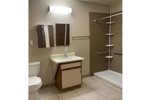 a bathroom with a toilet sink and mirror