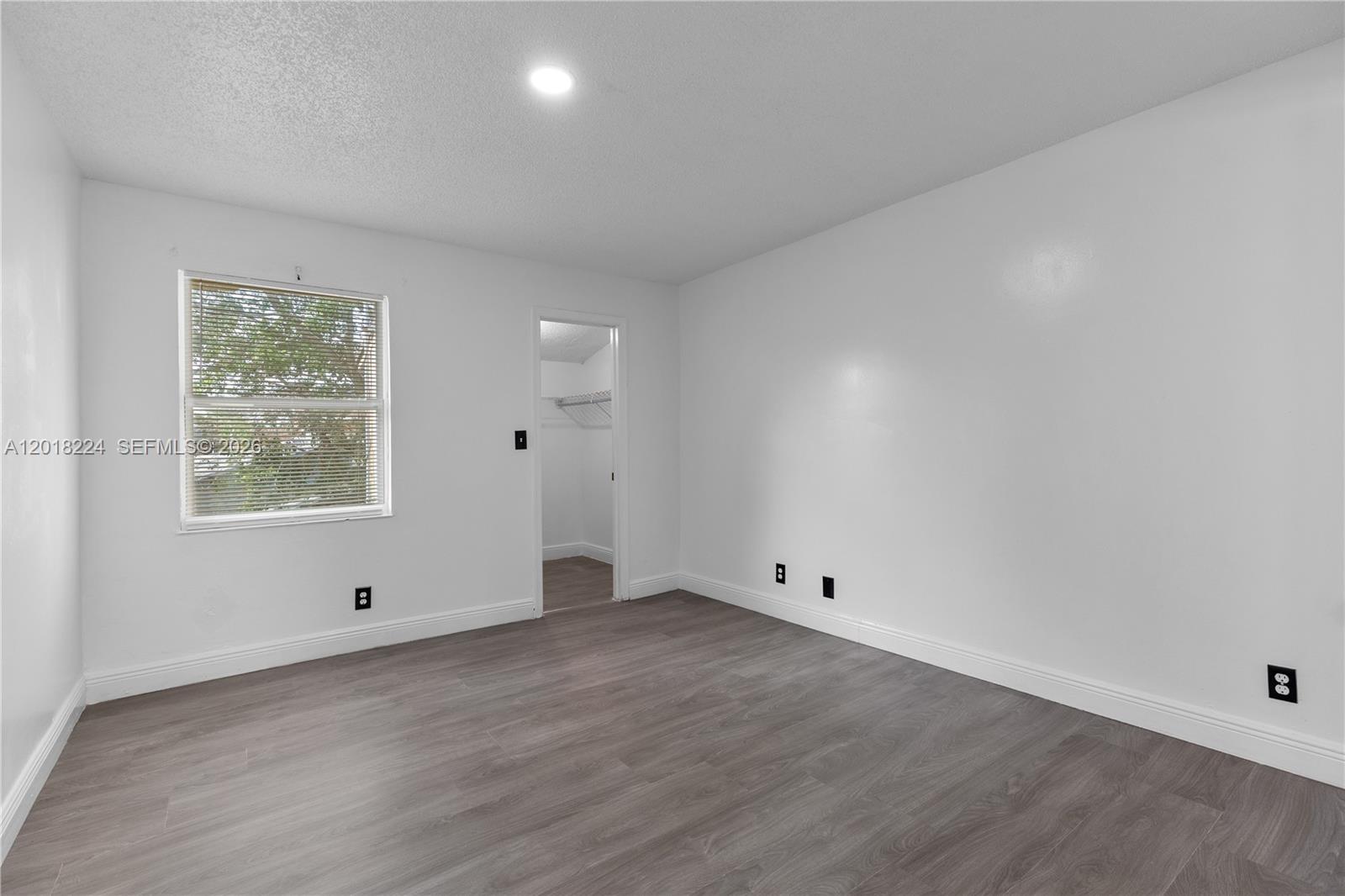 7958 Southwest 6th Street Pompano Beach, FL 33068 - Photo 21 of 57 wooden floor in an empty room with a window