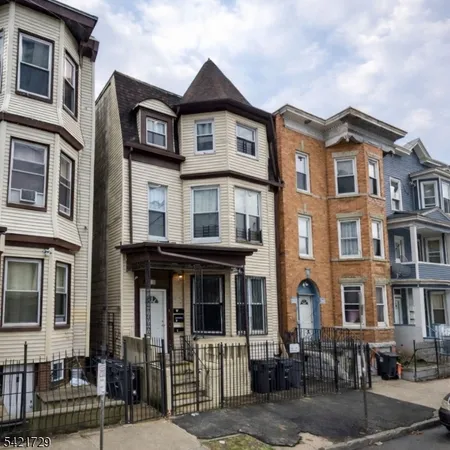 a front view of a residential apartment building with a yard