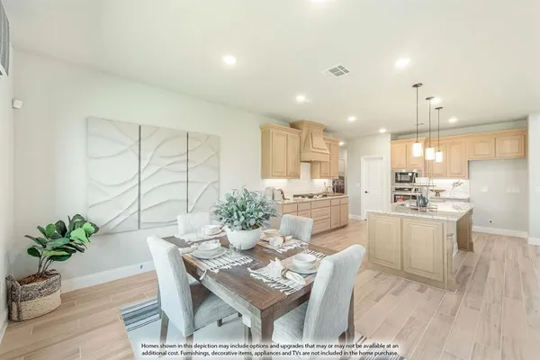 a living room with kitchen island furniture and a potted plant