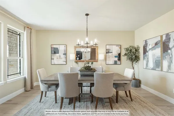 a dining room with furniture a chandelier and wooden floor