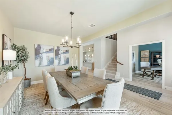 a dining room with furniture a chandelier and wooden floor